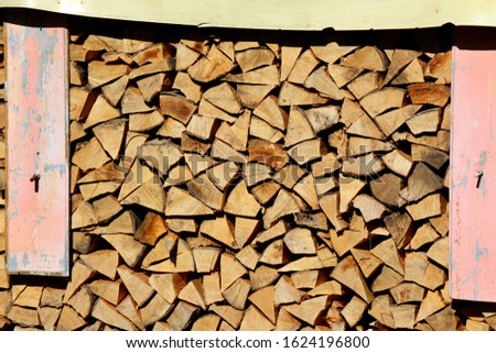Beautifully aligned chopped wood for heating in the fireplace.