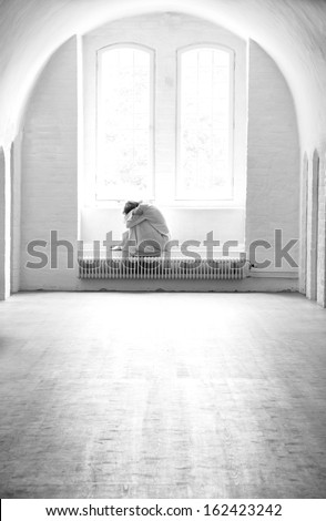 Depressed woman lonely in a mental institution. Royalty-Free Stock Photo #162423242