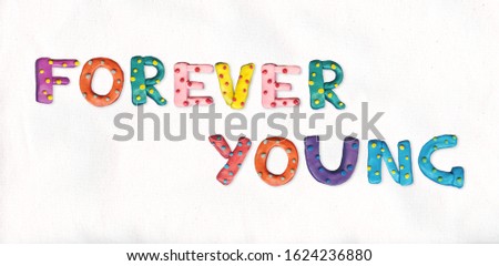 Inscription "forever young" made from plasticine of different colors. Clay ABC. Childish alphabet. Unique font.