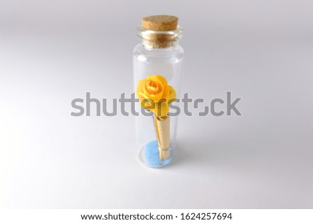 Small yellow rose That is in a small glass bottle With love letters.Valentine's.Valentine's day.