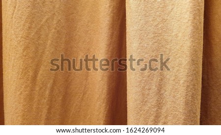Texture of yellow robe of Buddhist monk. Ordained Buddhist Monk's Traditional Saffron Robe Texture Pattern Backdrop Background. 