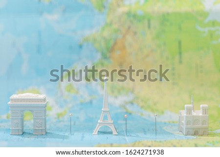 small figurines with city attractions on map of paris