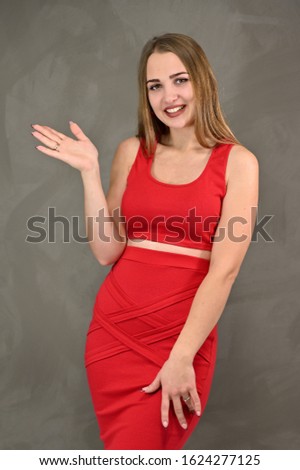 Vertical photo of a pretty smiling girl with long hair and great makeup in a red dress with emotions in different poses. Universal concept of a female portrait.