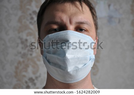 A man has a protective mask against viruses on his face. Virus Prevention.