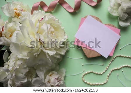 spring composition. a bouquet of pink peonies, women's accessories and place for text