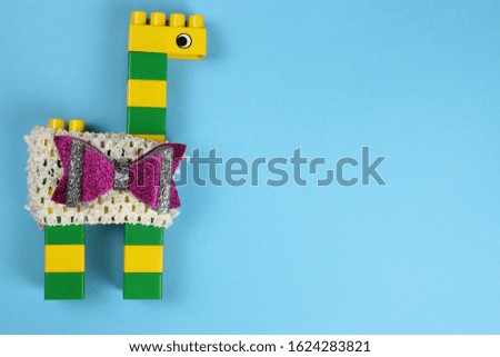 Giraffe from a colored children's block constructor. Space for text