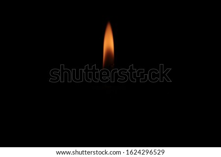 Red candle burns fire background