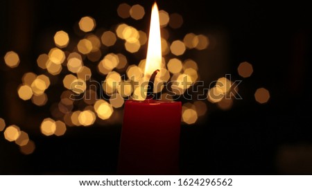Red candle burns fire background