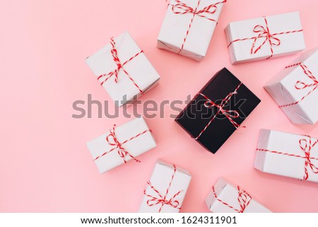 white boxes with gifts tied with red thread on a pink background. Be special. stand out from the crowd. Cute, light background for Valentine's Day, Women's Day, Mother's Day, Christmas.