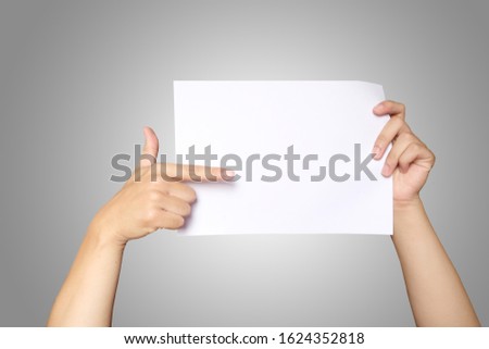 Close up of Asian men hands holding the white blank paper isolated on grey white background. Clipping path.