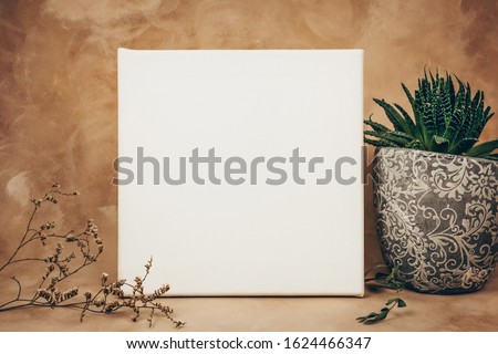 Blank empty canvas frame in interior. Mockup poster, blank space for message or art picture.