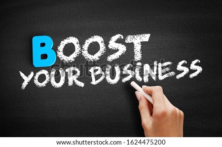Boost Your Business - to enhance or improve the performance, growth, or success of a business, text concept on blackboard