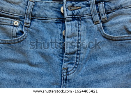 part of the pocket, on jeans with beautiful embossed stitching, seam, fabric texture, close-up, copy space