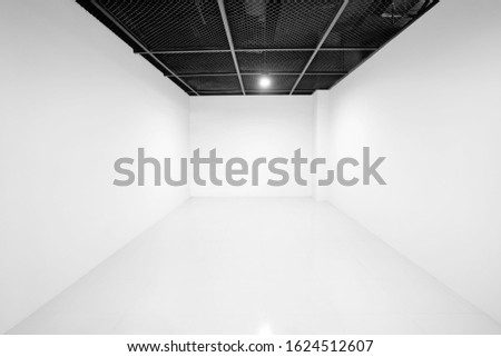 Empty white room, Above the ceiling is a black metal grille.