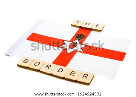 The national flag of Northern Ireland on a white background with a sign reading The Border