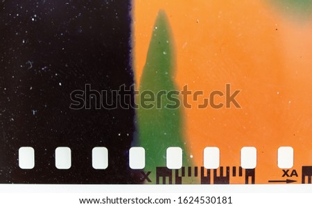 real macro photo of exposed 35mm film material with light leaks or sunstrokes, negative film strip template, color 135 type.