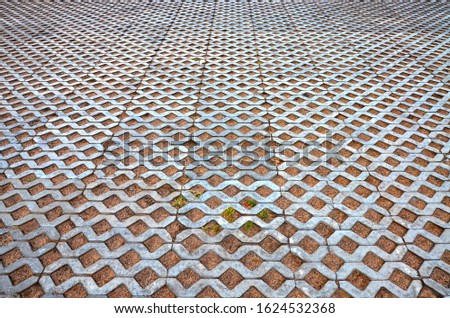 Old concrete pavers on the square, beautifully and evenly laid tiles, texture background