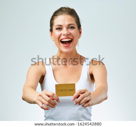 happy woman in white casual vest holding credit card in front of. isolated female portrait.