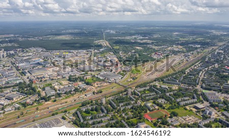 Aerial view photo from flying drone panoramic view of Riga's bridges, the Daugava River, the TV Tower and the city skyline on a sunny summer day in Riga, Latvia. (series)