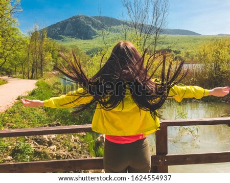 girl in a bright jacket on the lake