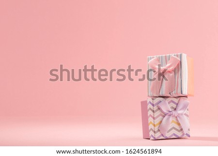 Two gift boxes on pink background with copy space. Beautiful little package for jewelry presents.