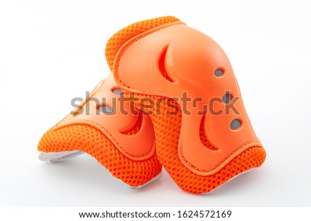 Cycling safety equipment, extreme sports and bicycle riding gear conceptual idea with orange knee pads isolated on white background with clipping path cutout Royalty-Free Stock Photo #1624572169