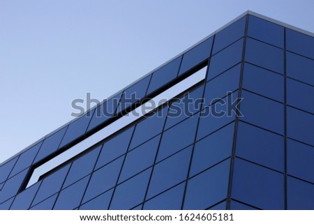 Digitally altered (by partial isolation) low angle photo of multistory building with glass panels facade wall. Modern business architecture. Office windows background. Urban corporate real estate. 
