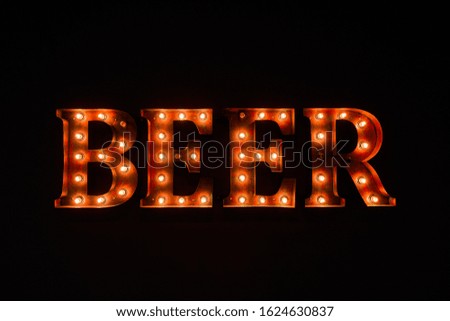 large luminous inscription BEER from light bulbs, in the dark