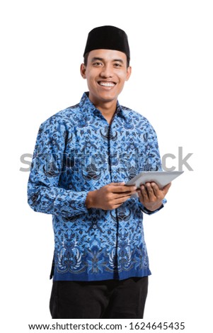asian young man wearing batik korpri using tablet digital, government officials of Indonesia