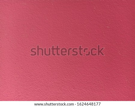 The background is made of pink colored concrete.