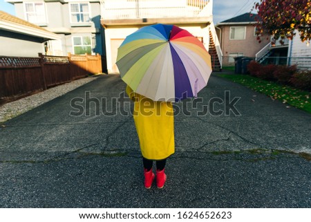 girl under a multi-colored umbrella. bright picture