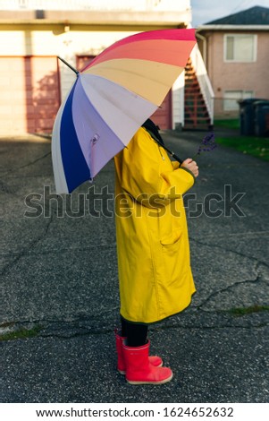girl under a multi-colored umbrella. bright picture