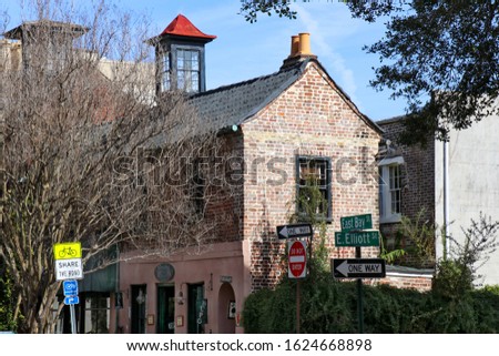 A picturesque old brick building at  with a glass cupola and double terra cotta chimney pipes, on East Bay Street in Charleston, SC.