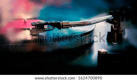 vintage record player, While playing the record, picture in blue tones.