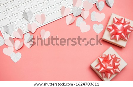 Keyboard and pink hearts on pastel pink background. Valentine day concept, design. Flat lay, top view, copy space
