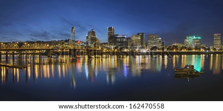 Portland Oregon Downtown Skyline with Hawthorne Bridge Along the Banks of Willamette River at Evening Blue Hour Panorama