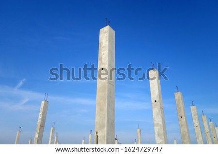 Concrete construction posts against blue sky. Architectural background                       
