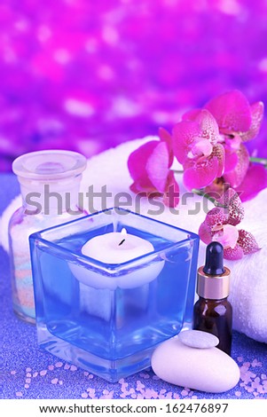 Beautiful spa setting with orchid on purple background