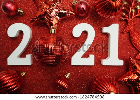 2021 with christmas ball decoration Flat lay on red glitter background