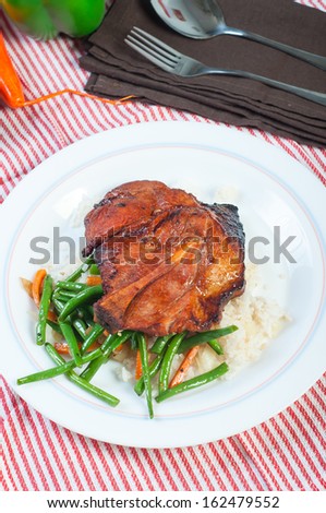 pork barbecue steak with french beans and carrots on garlic rice