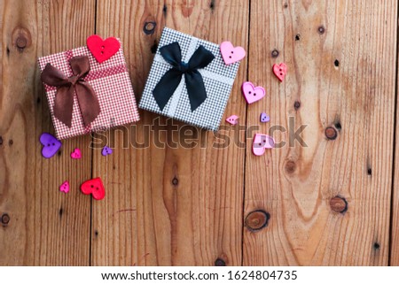 Black and brown Gift box on wooden table.