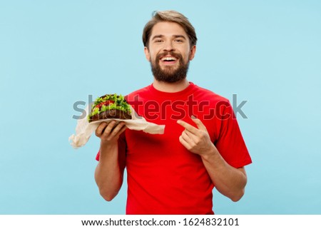 Red shirt man fresh hamburger vegetables meat