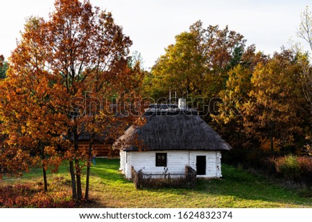 Old traditional polish wooden house in an open-air museum of Kielce (Muzeum Wsi Kieleckiej), Tokarnia, Poland, Europe. Picture taken during famous polish golden autumn.