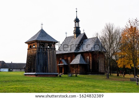 Old traditional polish wooden church in an open-air museum of Kielce (Muzeum Wsi Kieleckiej), Tokarnia, Poland, Europe. Picture taken during famous polish golden autumn.