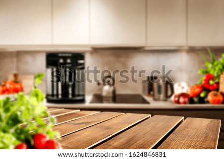 Table background in home interior and blurred furniture of kitchen 
