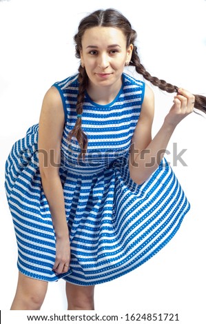 A girl in a striped dress, nautical theme; vest; coloring of the dress; the wind lifted the hem; black panties are visible;