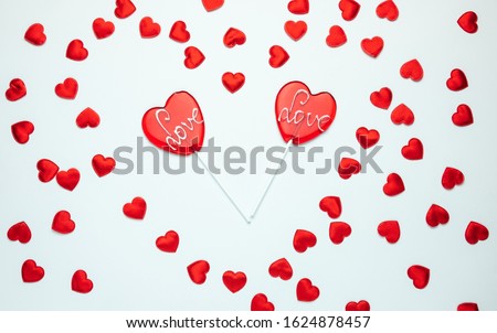Two heart shaped lollipops with Love inscription. Valentine's Day composition.