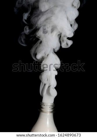 white smoke blowing from bottle
