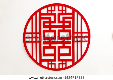 Chinese wedding symbol paper cut stick on the wall of bride's room. Chinese words "Double Happiness" for love and wedding. Text Calligraphy "Double Happiness" on paper cut design.
