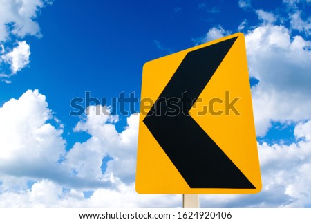 Yellow traffic signs with a background in the sky.